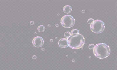 Transparent soap bubbles floating in the air on a black background with colorful light reflections