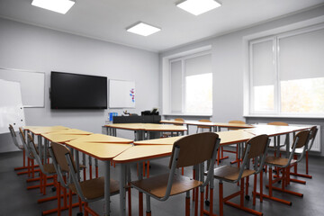 Classroom with yellow desks and chairs at school