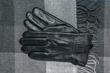 Elegant Black Leather Gloves on Stylish Gray Patterned Fabric Surface