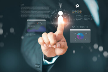 Businessman touching digital customer icon with data dashboards, analytics charts, and AI-driven insights representing CRM management, customer segmentation, and smart marketing optimization.