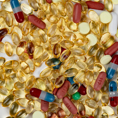 Macro close up of a lot of pain pills and supplements