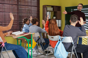 Teacher and students during lesson in classroom