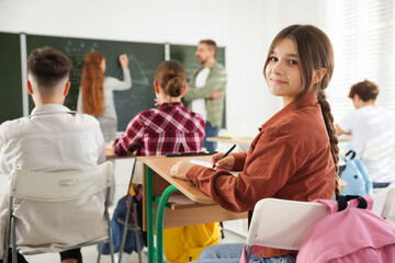 Teacher and students during lesson in classroom, selective focus