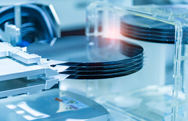 Semiconductor and Computer Chip Manufacturing at Fab or Foundry with robotic arms with silicon wafers