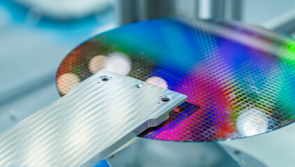 Semiconductor and Computer Chip Manufacturing at Fab or Foundry with robotic arms with silicon wafers