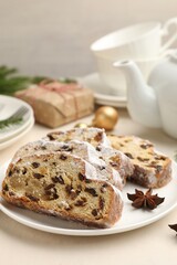 Slices of Stollen (traditional Christmas cake) served on white table, closeup