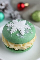 Tasty macaron and Christmas decor on white table, closeup