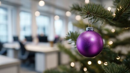 Purple christmas ornament on tree branch in modern office environment