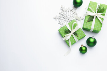 Beautiful Christmas composition with gifts and decor on white background, flat lay. Space for text
