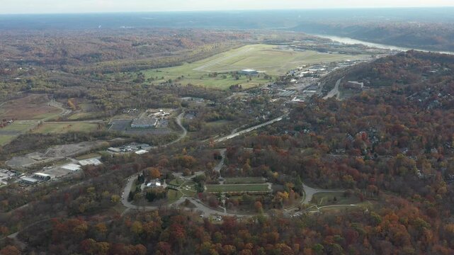 Aerial view of Ault Park surrounded by vibrant autumn foliage, with the Ohio River winding in the distance, Cincinnati, Ohio, United States.