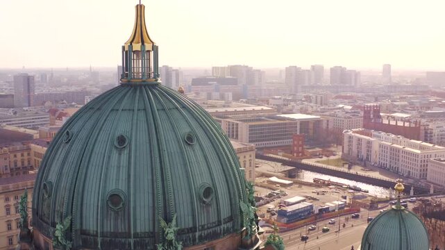 Aerial view of the majestic Berlin Cathedral with its copper dome contrasting against the backdrop of the city buildings, Berlin, Berlin, Germany.