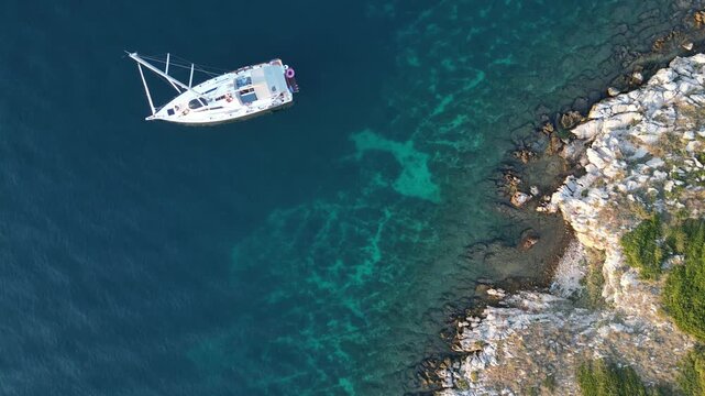 Aerial view of the vibrant turquoise waters surrounding a reef, with a boat navigating the diverse marine environment, Siargao, Philippines.