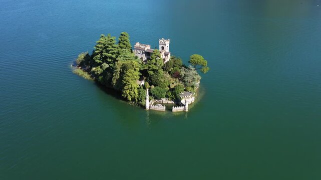 Aerial view of the enchanting Loreto Island, where a historic castle rises amidst lush greenery, surrounded by the tranquil waters of Lake Iseo, Iseo, Lombardia, Italy.