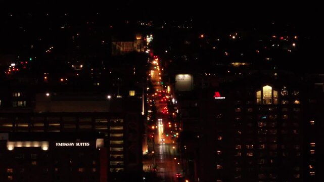 Aerial view of city streets illuminated by streetlights, adjacent to the Embassy Suites and Marriott buildings, captured at night, Cincinnati, Ohio, United States.