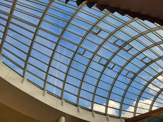 Oval glass decorative ceiling against a blue sky, modern design