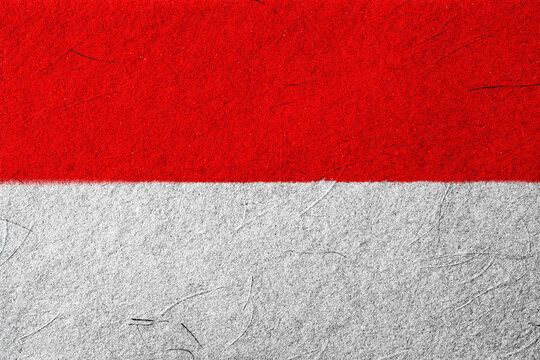 A vibrant, textured background featuring the bold horizontal bicolor of red and white evokes a sense of national pride and cultural identity, creating a symbolic and striking visual