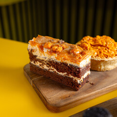 Decadent chocolate layer cake with creamy frosting and toasted crumble topping served on a wooden board