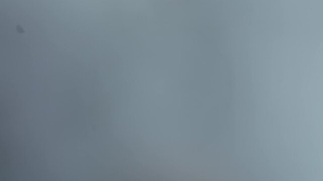 Aerial view of dense clouds and heavy fog creating a mysterious and ethereal atmosphere with muted and contrasting tones, Fellering, Grand Est, France.