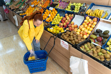Woman buying fresh fruits in spanish market