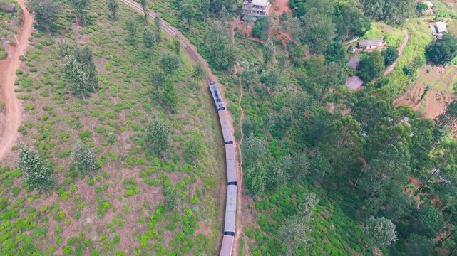 Scenic Drone View of Train Traveling Through Lush Mountain Sri Lanka