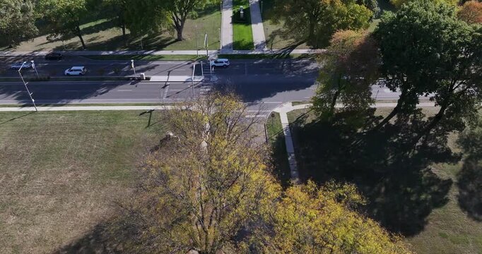 Aerial view of the imposing University Hall with its clock tower, set against trees and a clear sky, Toledo, Ohio, United States.