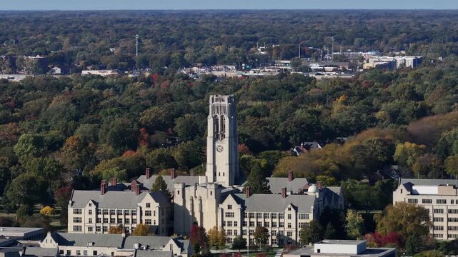 Aerial view of the University of Toledo's iconic clock tower and buildings nestled among lush trees and warm autumn colors, Toledo, Ohio, United States.