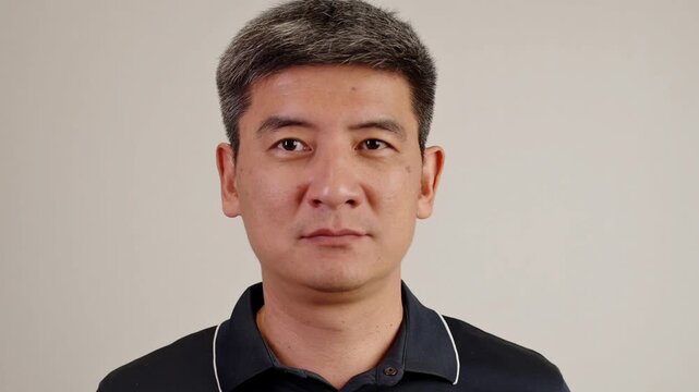 Handsome asian person shrugging his shoulders with confused and uncertain facial expression. Man expresses doubt, confusion, skepticism, indifference, or lack of information.