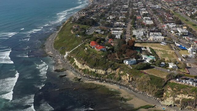 Aerial view of Yogananda Ashram on a cliff overlooking the ocean with cars parked nearby, Encinitas, California, United States.