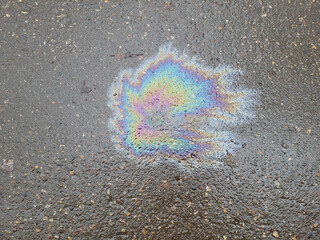 A beautiful bright multicolored spot on wet asphalt, viewed from above
