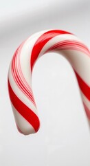 Red and white striped candy cane on white background  