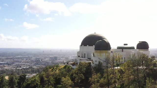 Aerial view of the Griffith Observatory perched atop the hills, overlooking the sprawling cityscape in the distance, Los Angeles, California, United States.