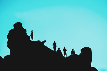 A group of people on a rock on a blue background