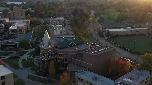 Aerial view of the buildings and sports fields of Xavier University campus during the golden hour with trees displaying fall colors, Cincinnati, Ohio, United States.