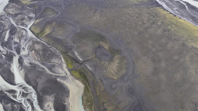Aerial view of glacial rivers weaving through volcanic ash in Landmannalaugar, the textures create a stunning contrast of colors, Rangarthing ytra, Iceland.