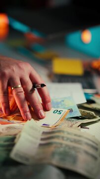 Euro Banknotes Contract Signature Financial Agreement Budget close-up view male hand signing contract beside scattered euro bills Concept salary finance savings budgeting transaction
