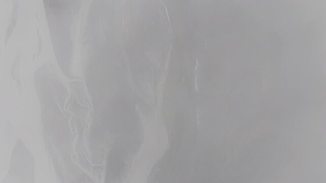 Aerial view of the ethereal and misty landscape, displaying subtle gradients and patterns in Landmannalaugar, Rangarthing ytra, Iceland.