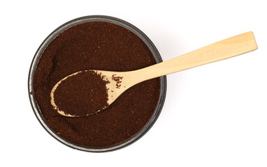 Ground coffee pile for espresso in plastic bowl with wooden spoon, isolated on white background, top view	