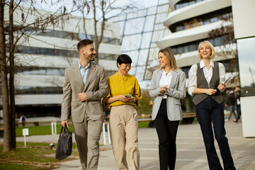 Business professionals walking outside a modern office building during the day