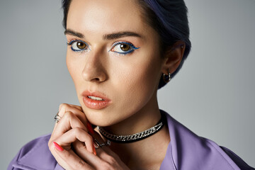 Obraz premium Stylish young woman poses gracefully with a confident expression, showcasing modern fashion trends