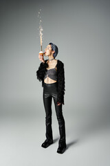 Young woman celebrates with sparklers in stylish fashion, capturing a moment of joy and bliss