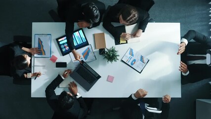 Time lapse of businessman using VR headset to visit virtual world while diverse start up team discuss about marketing strategy on table with financial graph placed at business meeting. Directorate. - Powered by Adobe