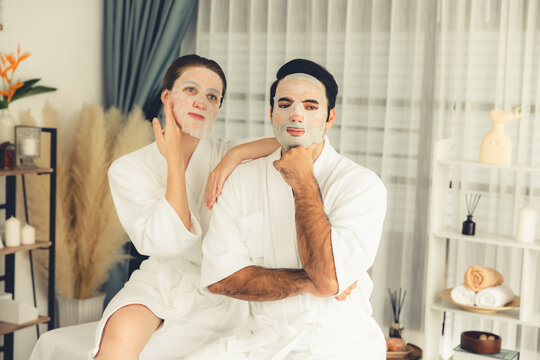Serene modern daylight ambiance of spa salon, couple customer indulges in rejuvenating with facial skincare mask. Facial skin treatment and beauty cosmetology procedure for face. Quiescent - Powered by Adobe