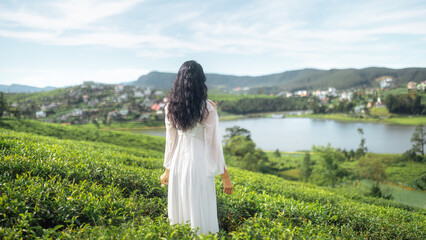 Woman in White Dress Overlooking Tea Fields and Lake Gregory, Sri Lanka