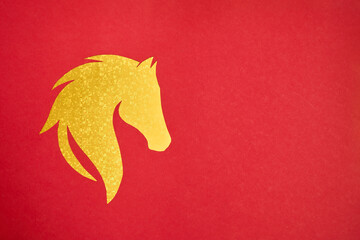 Golden horse silhouette on red background. Symbol of prosperity and strength in festive Chinese New Year 2026