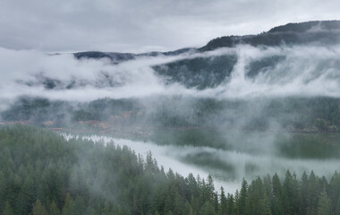 Misty Mountain Lake With Fog And Dense Forest In British Columbia, BC, Canada