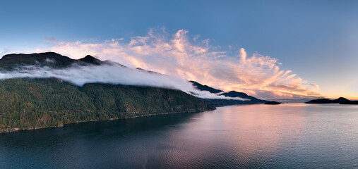 Sunset Over Misty Mountain Range and Calm Coastal Waters in British Columbia, Canada Nature Scenery