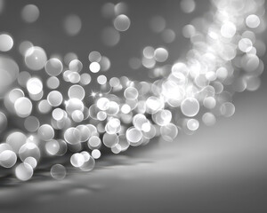 White sparkling bokeh lights create magical and festive atmosphere with soft glowing circles on smooth gray background, perfect for elegant and dreamy designs