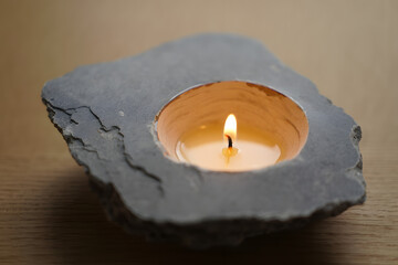 Natural stone candle holder with glowing tea light