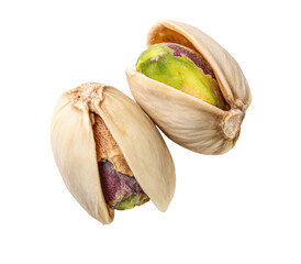 Two pistachios in their shells, close-up.  The light beige shells are slightly open, revealing the light green kernels inside.  A bit of  dark-purple staining is visible on one shell.