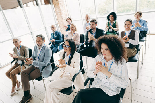 Business team applauding during a conference in a modern workspace, showcasing teamwork, diversity, professionalism